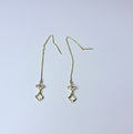 Long gold earrings.
