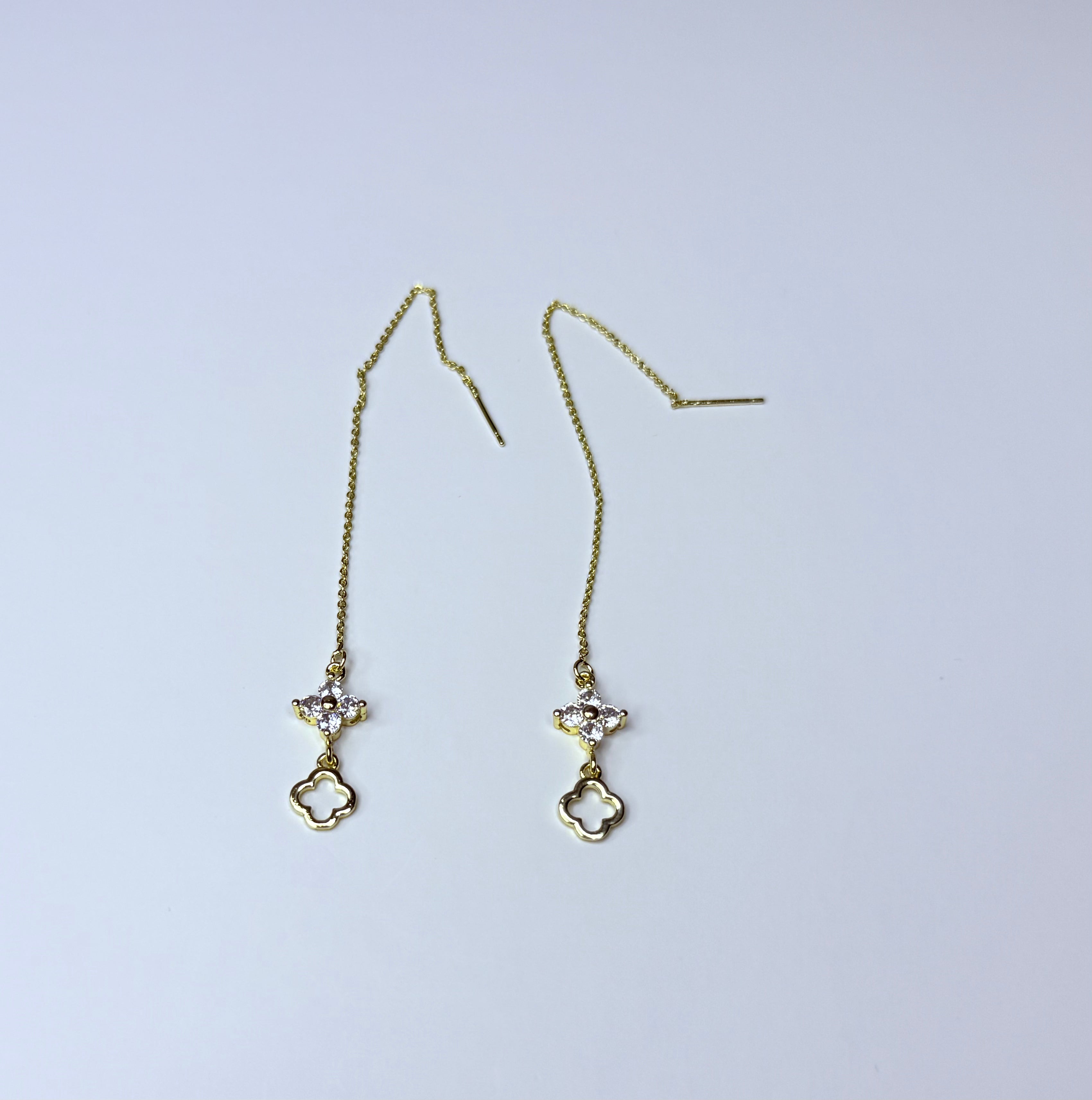 Long gold earrings.