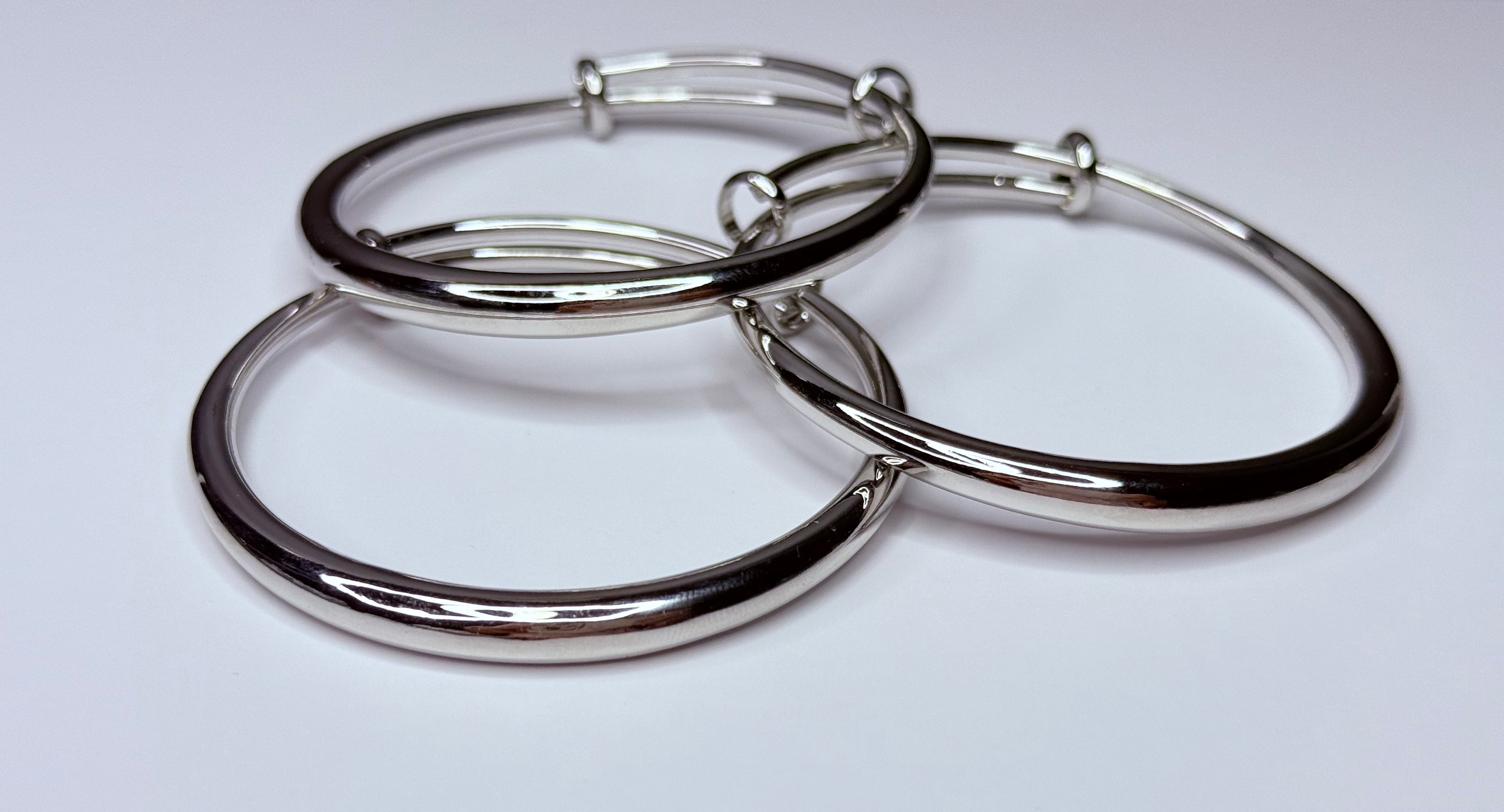 Silver bangle trio.