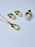 Freshwater pearl set with multicolored crystals.