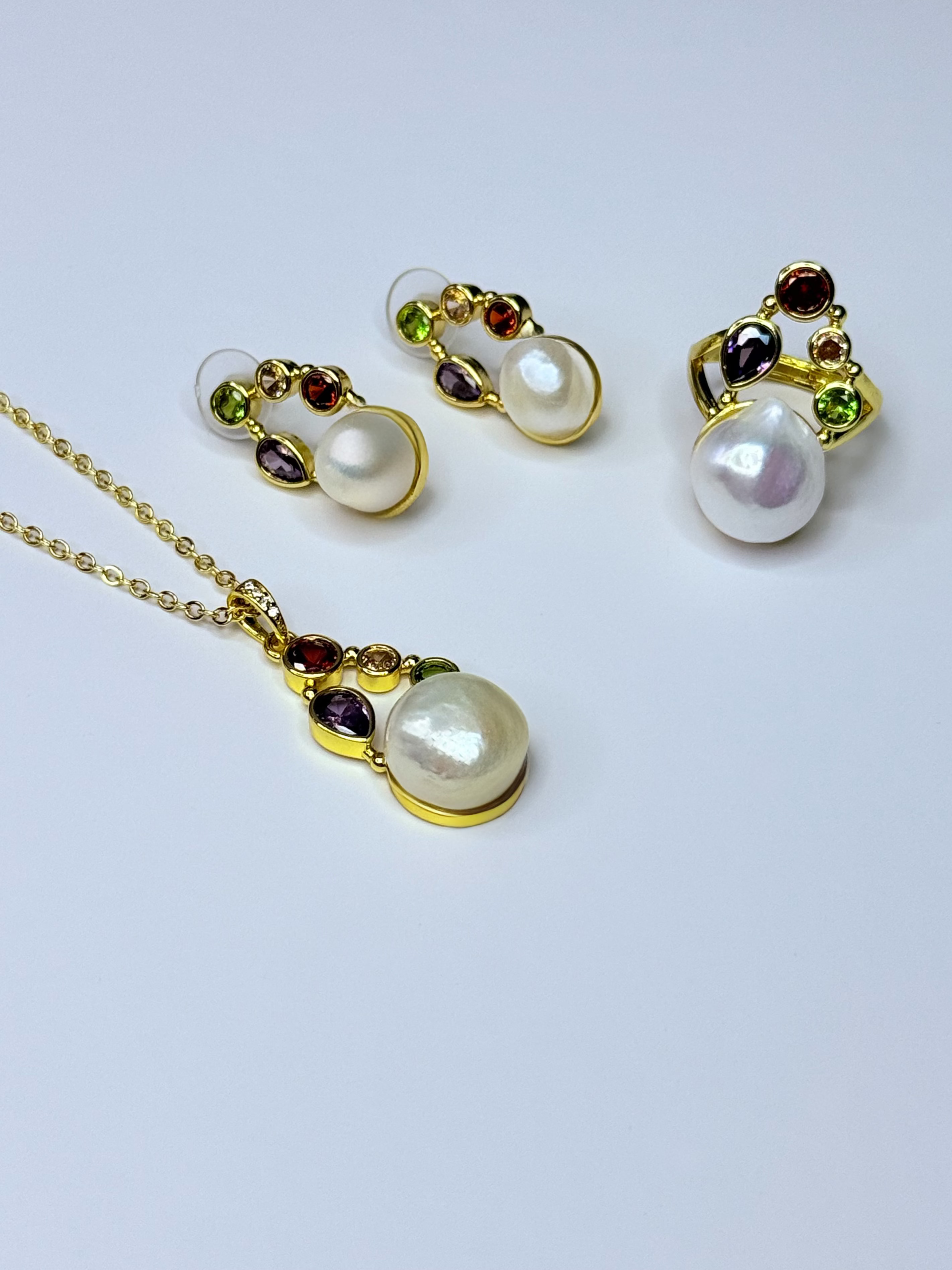 Freshwater pearl set with multicolored crystals.