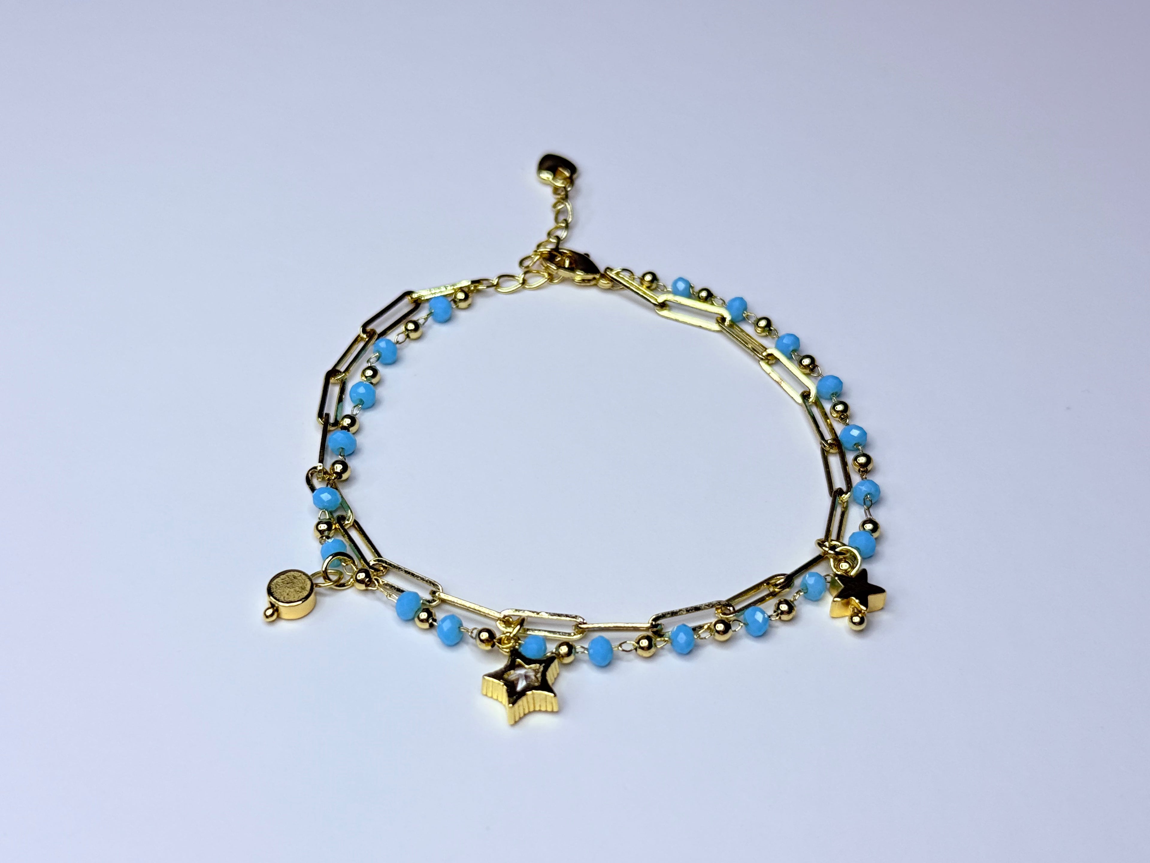 Paperclip bracelet with blue beads.