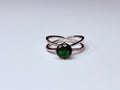 Green and silver infinity ring.