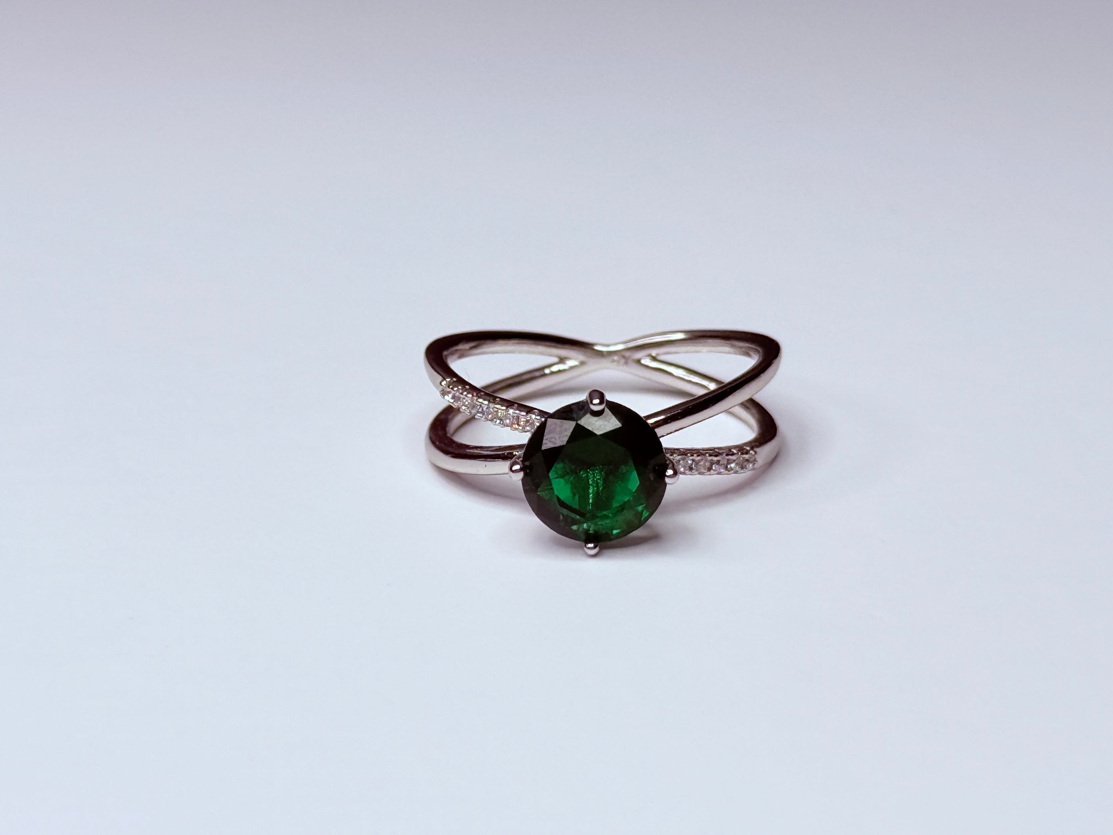Green and silver infinity ring.