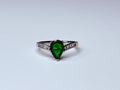 Green and silver crown ring.