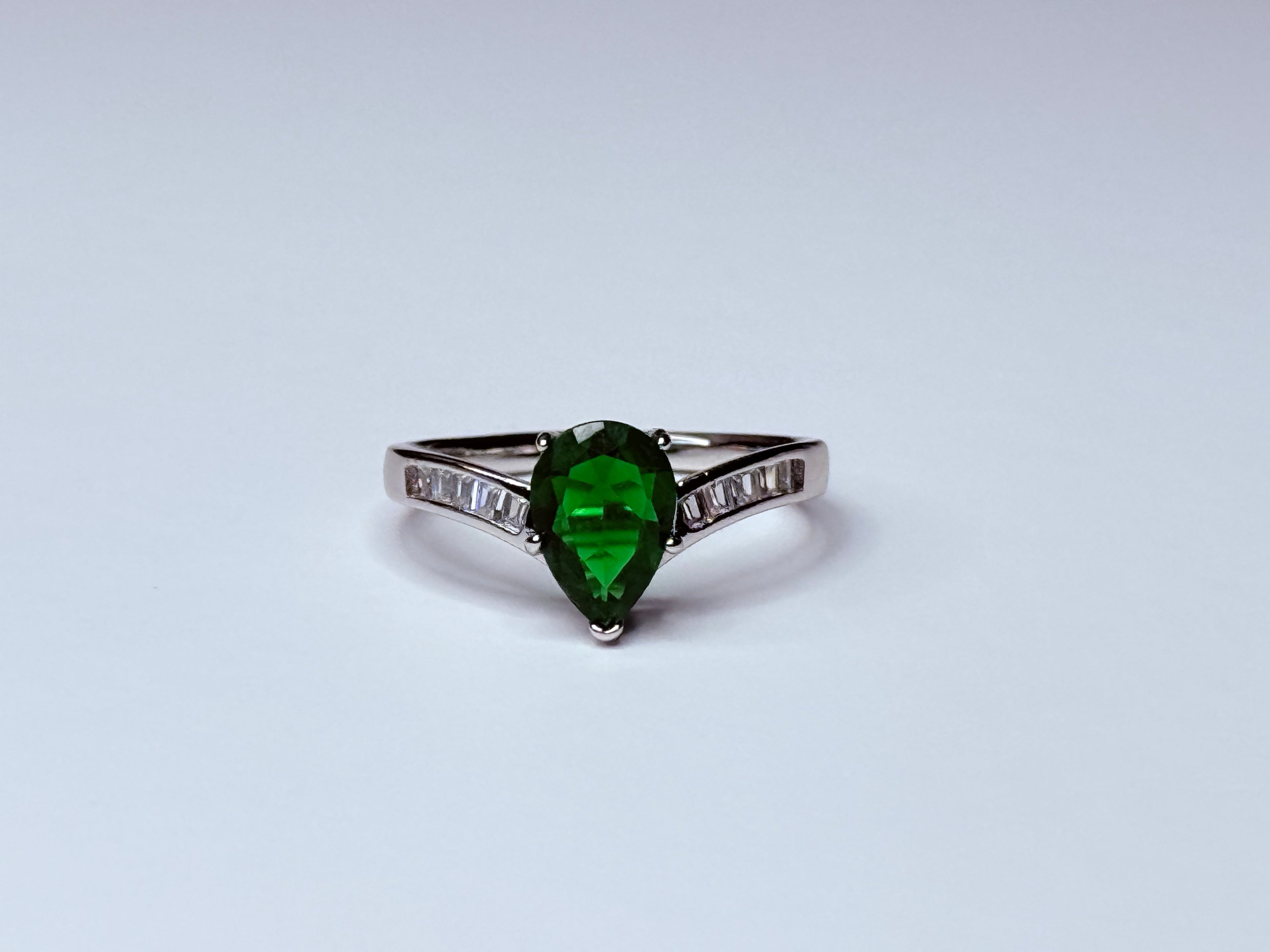 Green and silver crown ring.