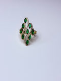 Peacock ring with green oval cubic zirconia.