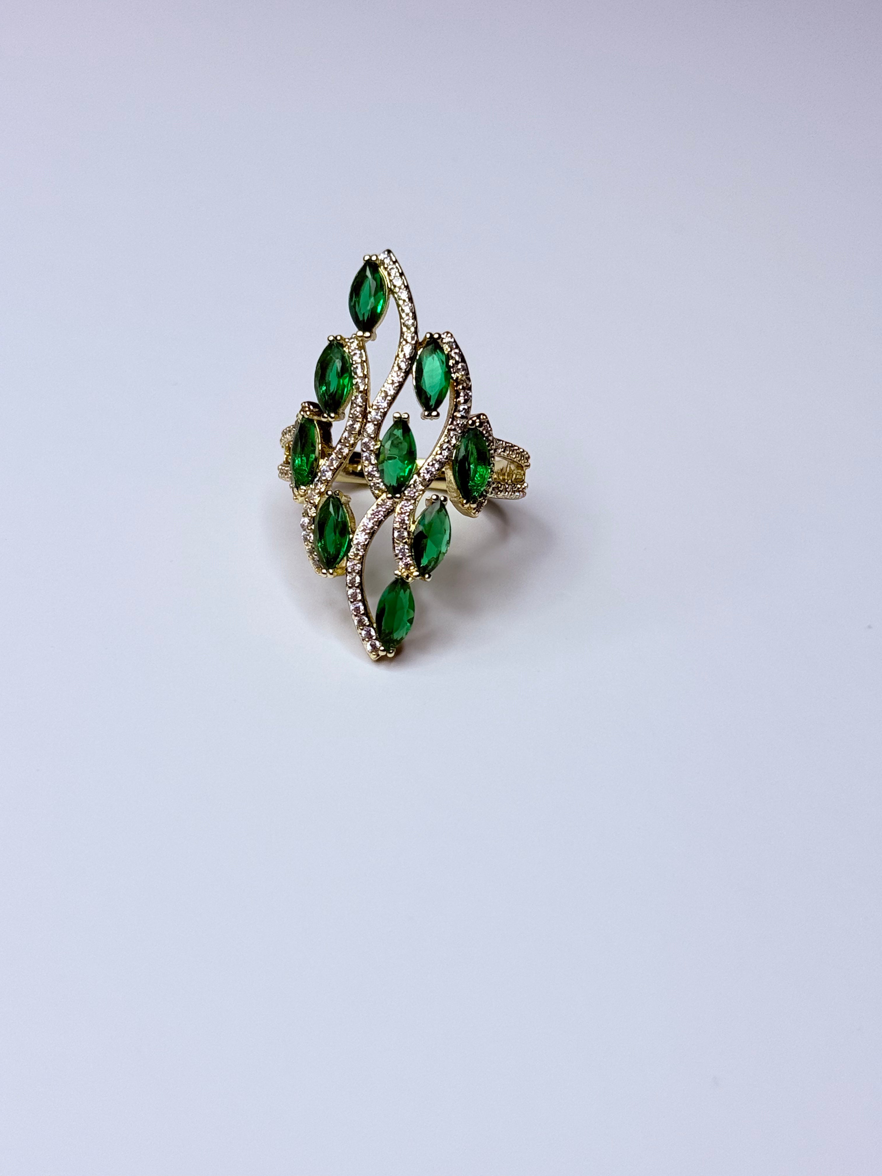 Peacock ring with green oval cubic zirconia.