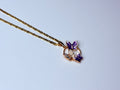 Rose gold violet butterfly necklace.