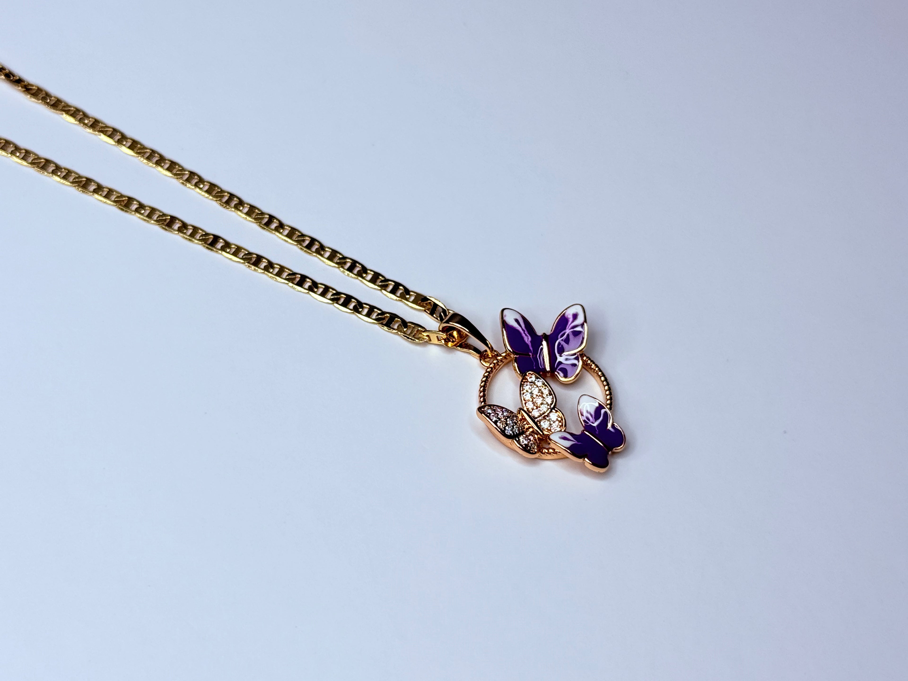 Rose gold violet butterfly necklace.