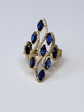 Peacock ring with navy blue oval cubic zirconia.