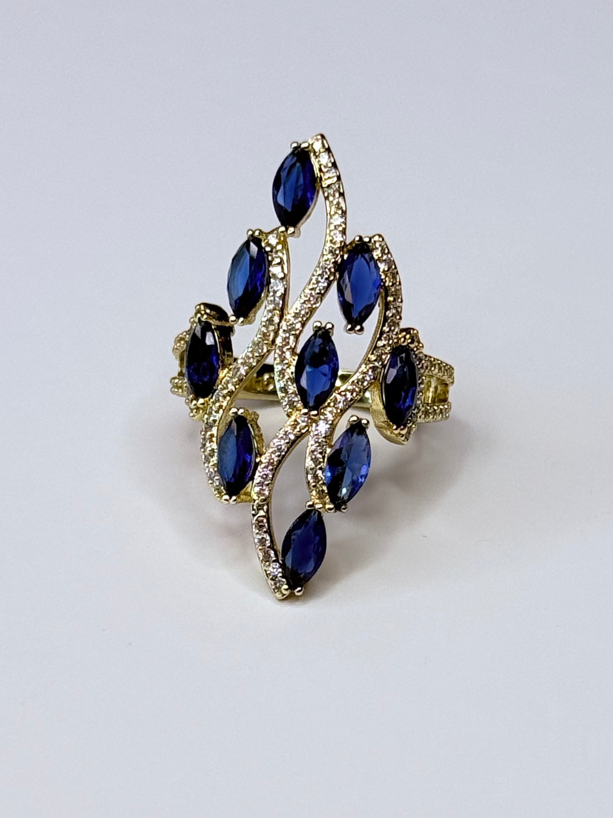Peacock ring with navy blue oval cubic zirconia.