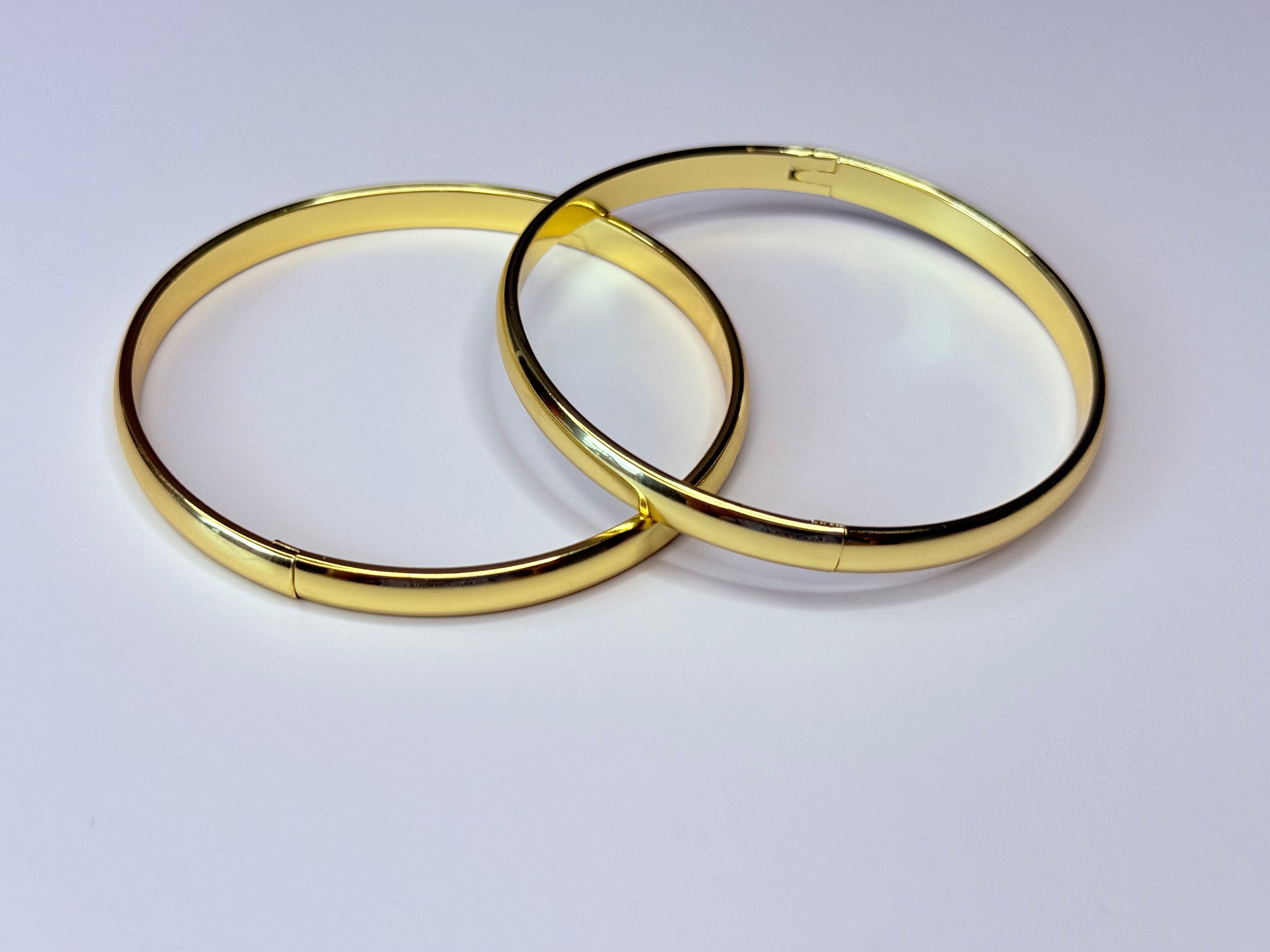 Thin gold bangles.