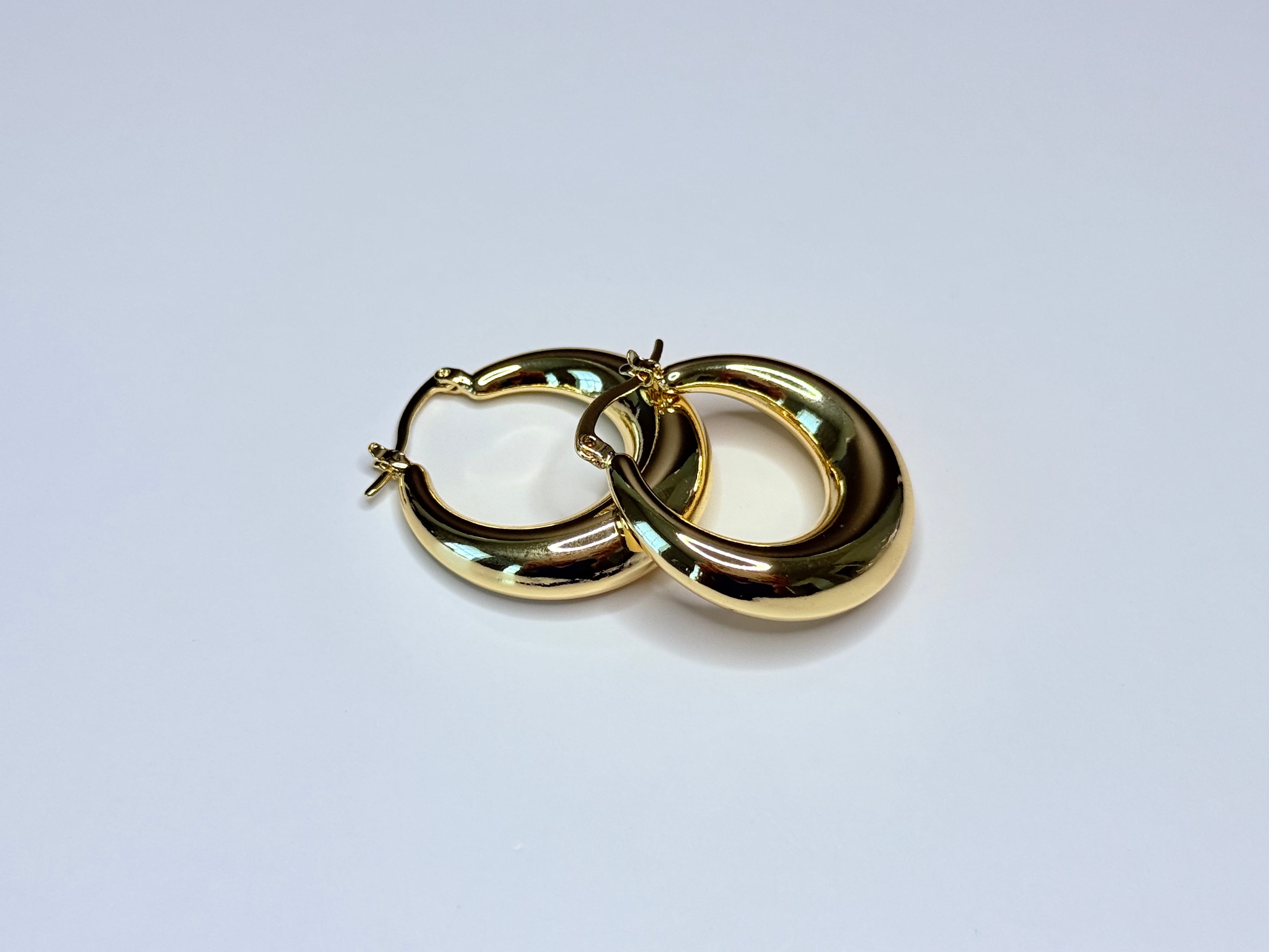 Chunky gold earrings.